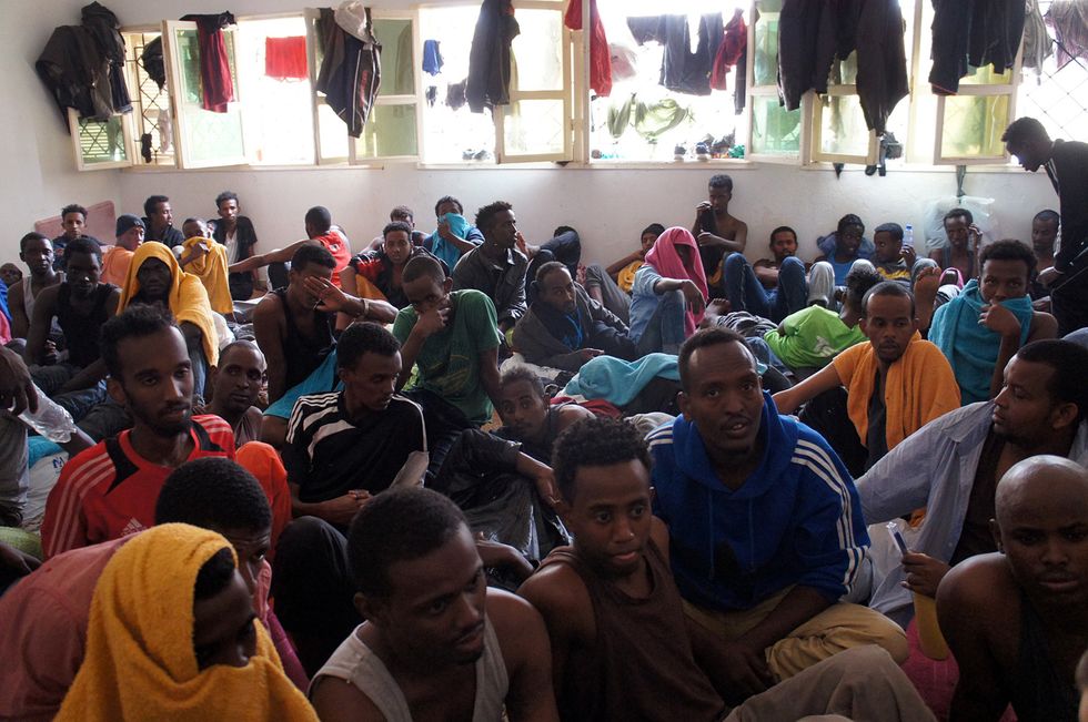 Migrants crowd in a small room in a detention centre in Misratah, Libya.