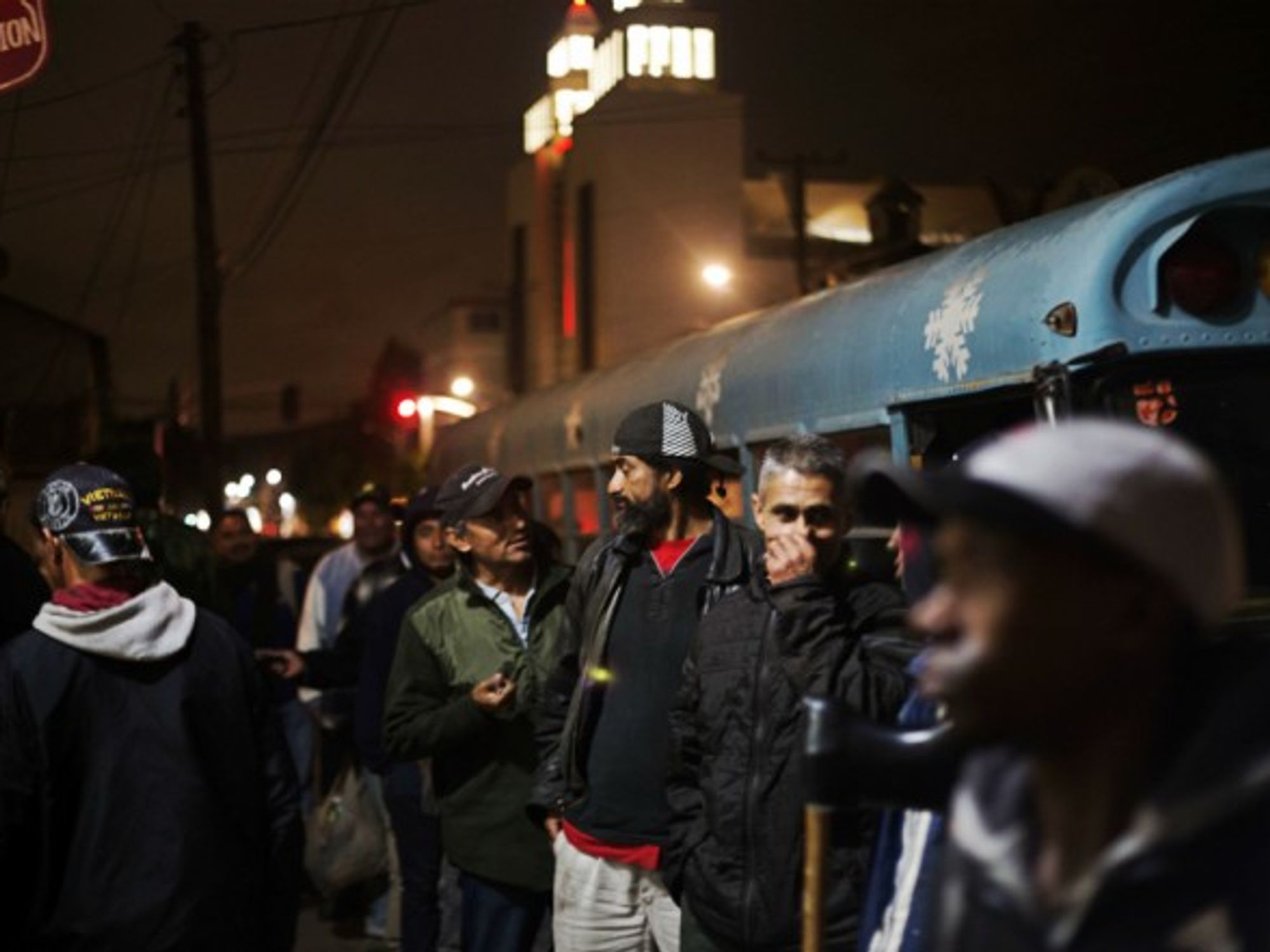 Migrants talking before they get into a shelter to rest, in Tijuana