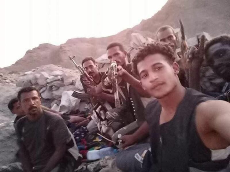 Militia gang holding guns.