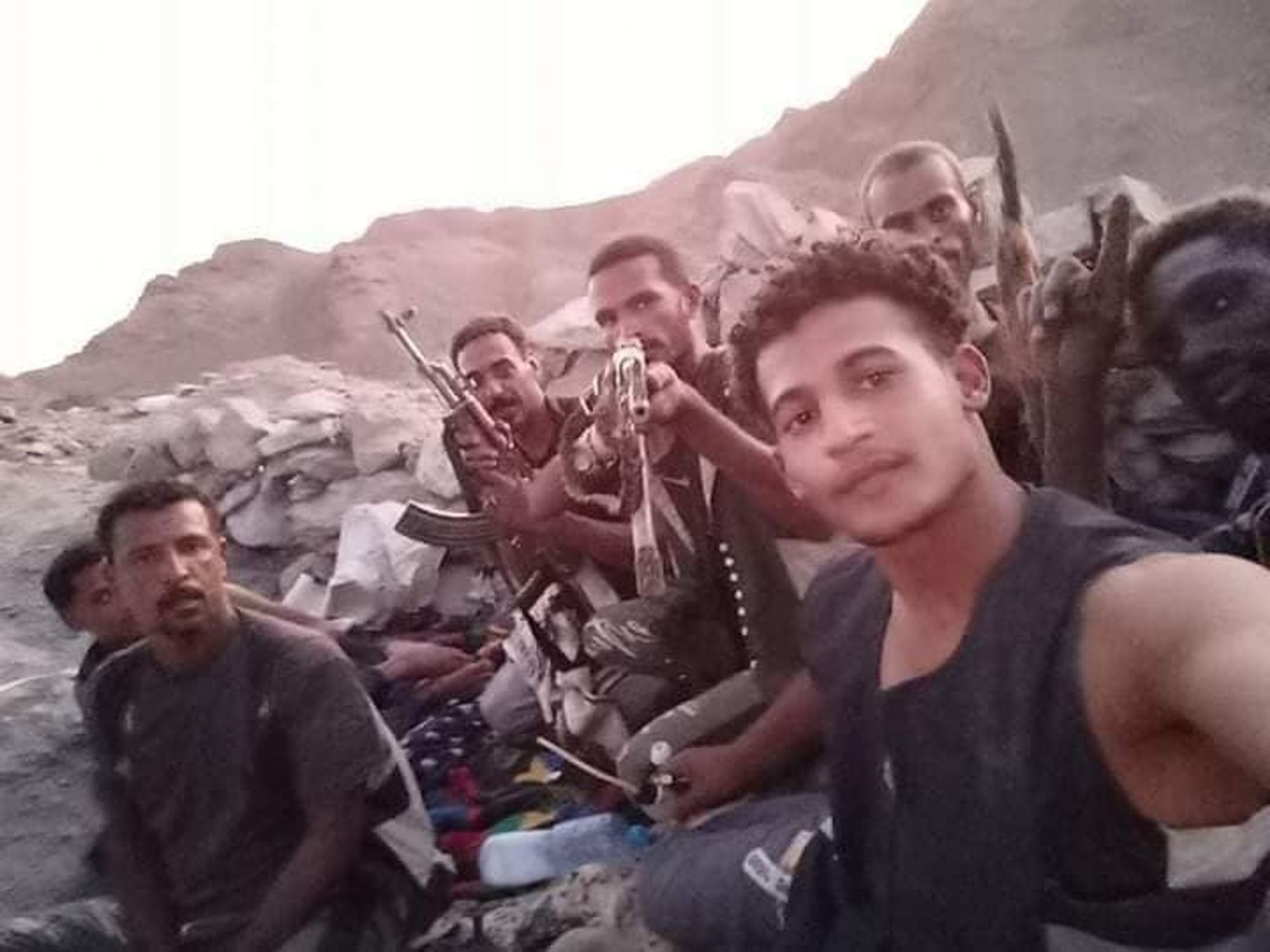 Militia gang holding guns.
