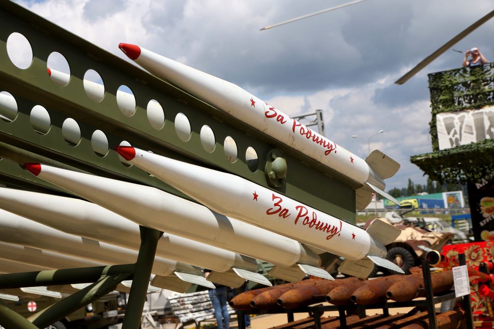 Missiles with the inscription 'for the motherland' on a military truck on display at an exhibition