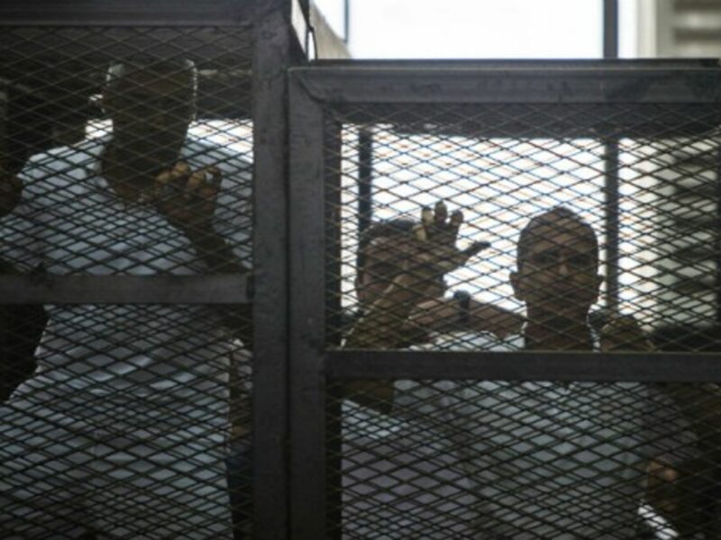 Mohamed Fadel Fahmy and Peter Greste listen to the verdict at a court in Cairo, June 23, 2014.