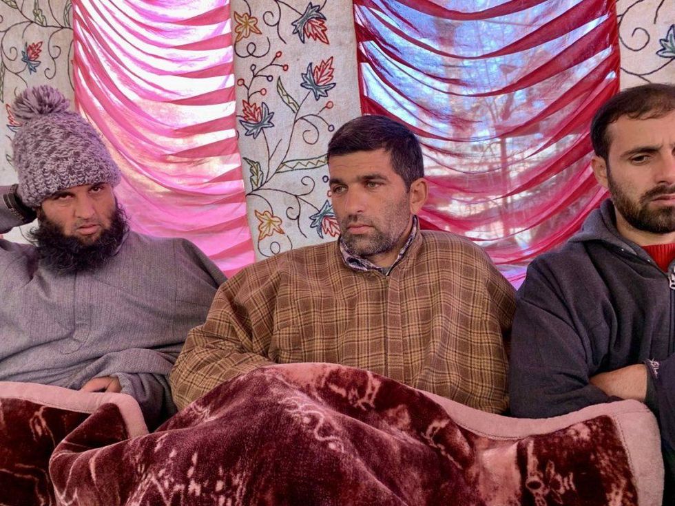 Mohammad Altaf, father of Afaan, one of the two minors who died in the outbreak, in a tent for mourners outside his house