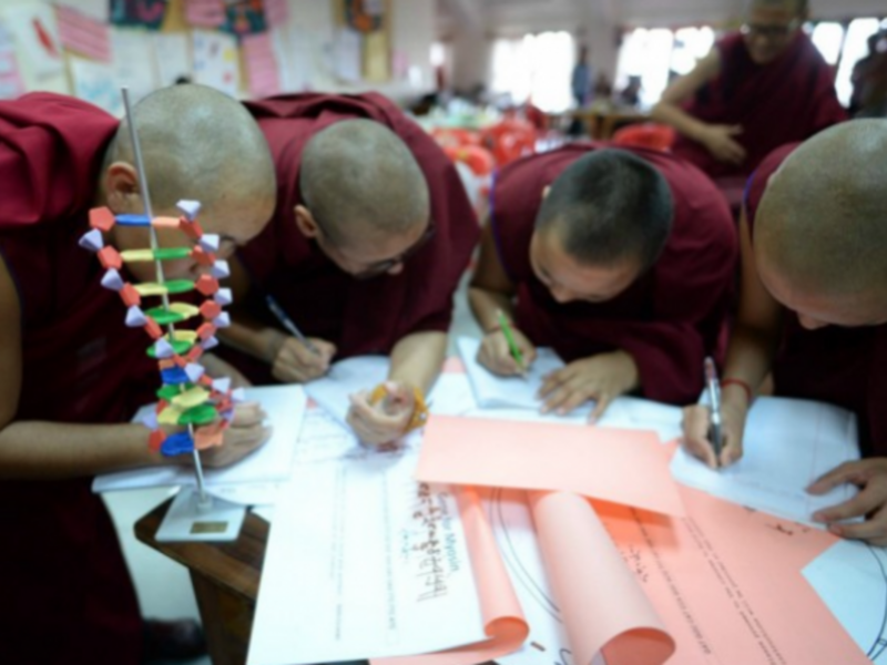 Monks working on a project with Science for Monks
