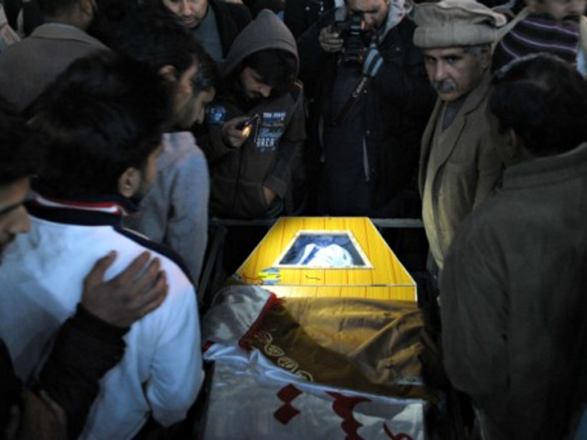 Mourners attend the funeral of a student who was killed in Tuesday's attack by Taliban gunmen on a school in Peshawar