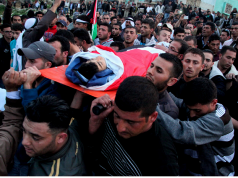 Mourners carry the body of a Palestinian teen killed by Israeli troops Wednesday.