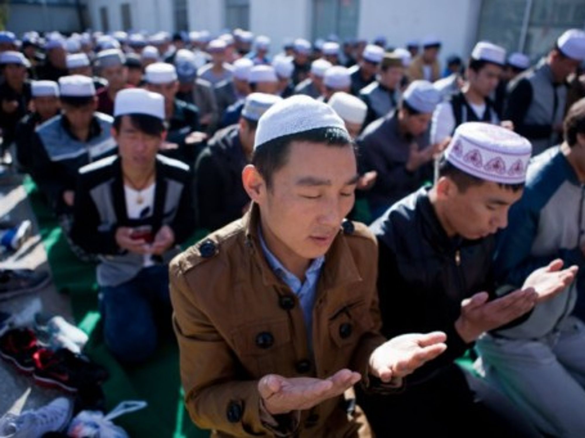 Muslims pray at a China mosque Sunday during the Eid al-Adha festival.