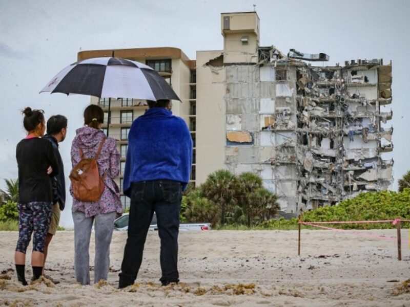 Neighbors look at rumble of a 12-story Miami building after its partial collapse