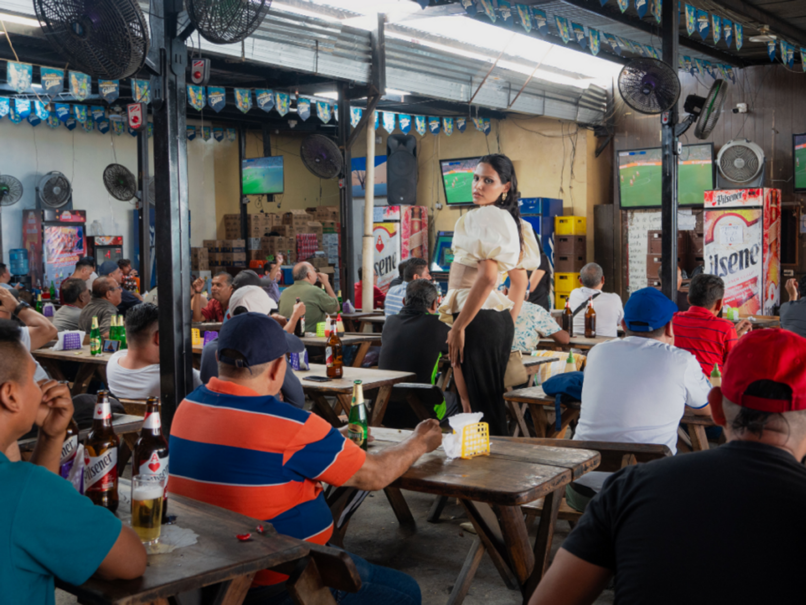Nessa Sosa standing in a bar during a soccer game.