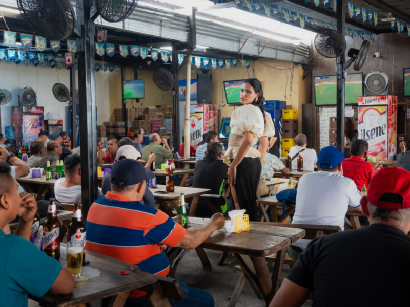 Nessa Sosa standing in a bar during a soccer game.