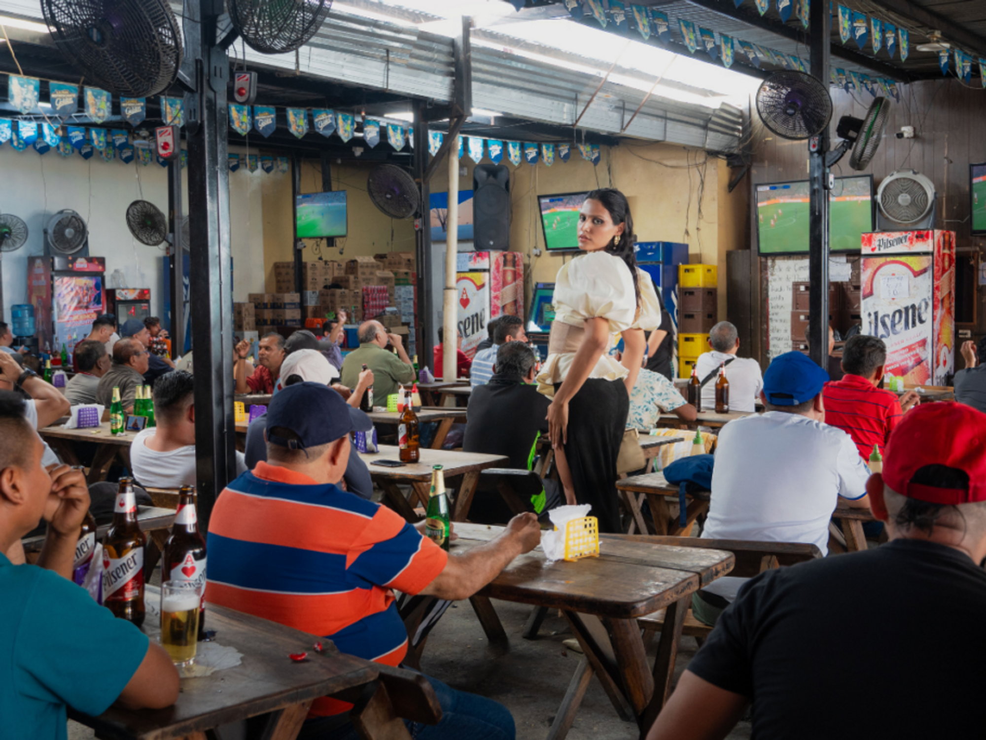 Nessa Sosa standing in a bar during a soccer game.