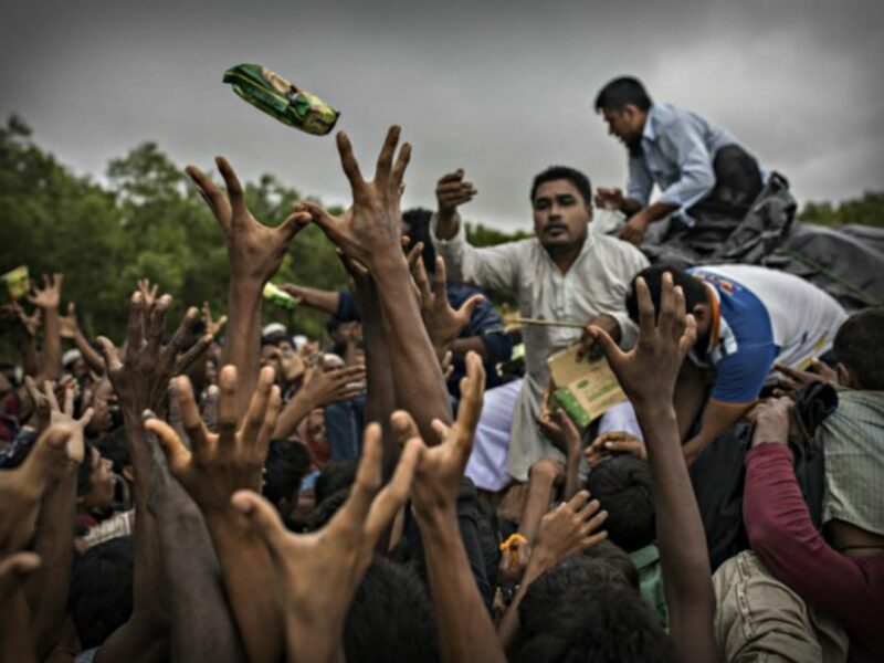 NGO workers distribute food to Rohingya refugees in Bangladesh