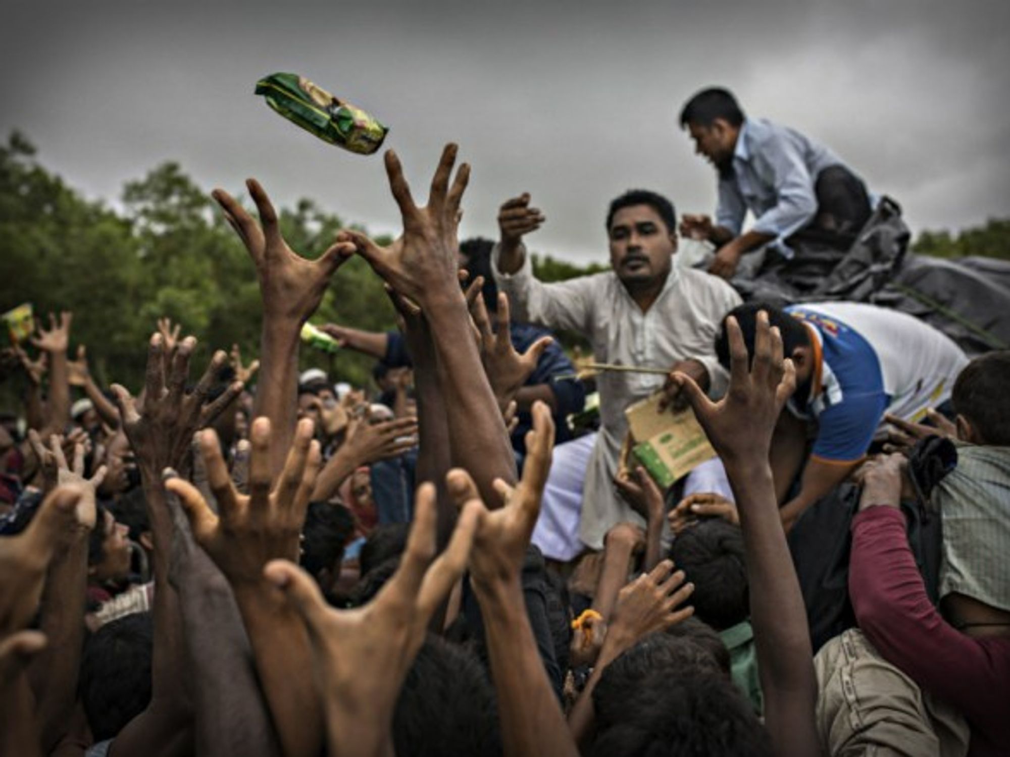 NGO workers distribute food to Rohingya refugees in Bangladesh