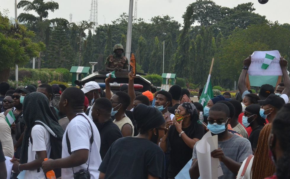 Nigerians demonstrate on the street to protest against police brutality in Abuja, Nigeria, on Oct. 13, 2020.