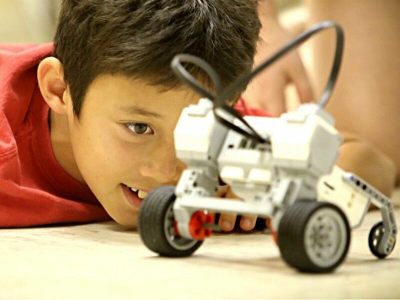 Nine and ten-year-olds test the RoverBot they worked on in an introduction to LEGO Mindstorms