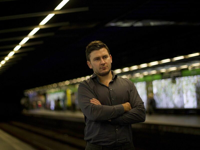 Novelist Dmitry Glukhovsky stands in a metro station in Barcelona