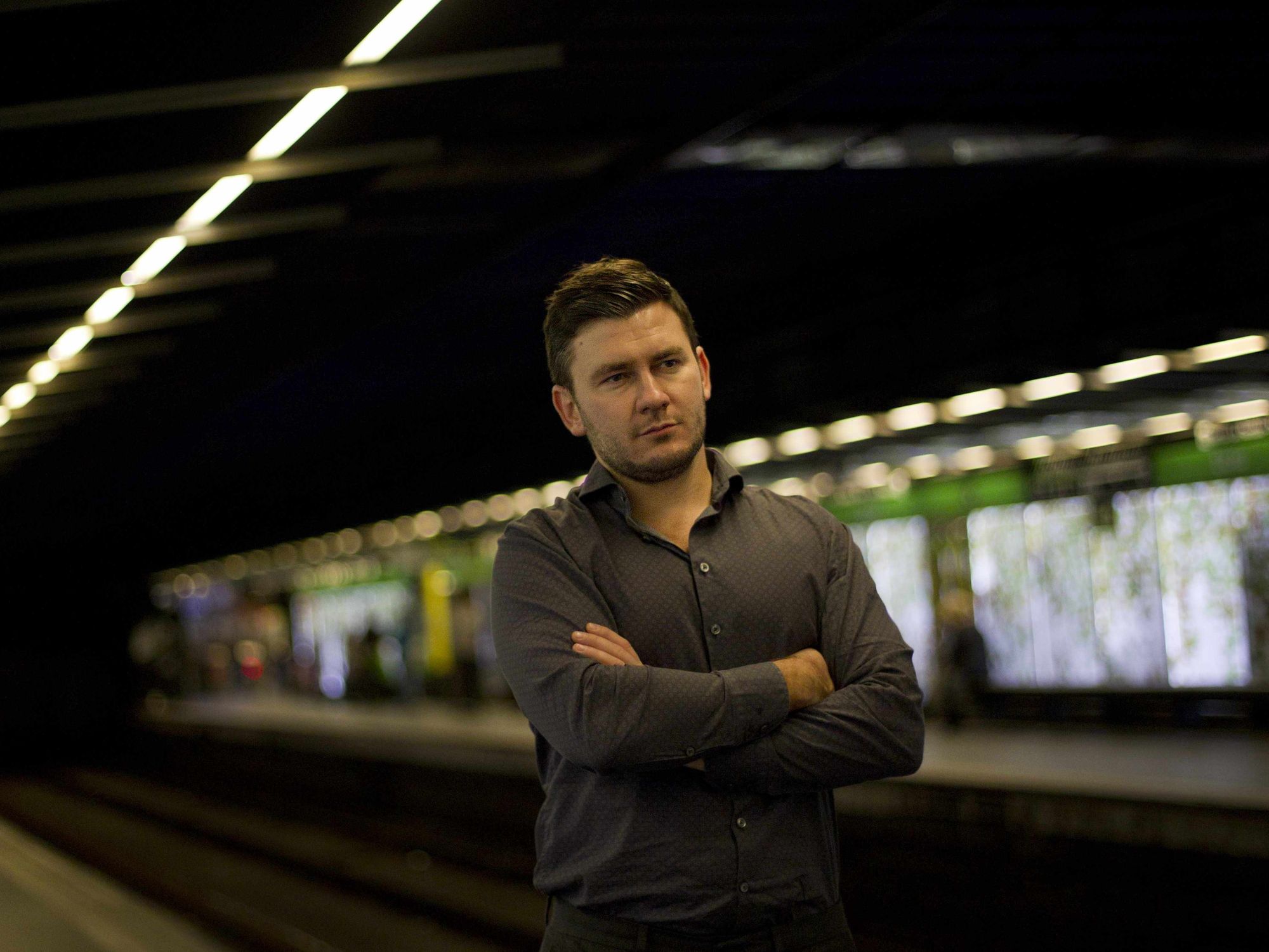 Novelist Dmitry Glukhovsky stands in a metro station in Barcelona
