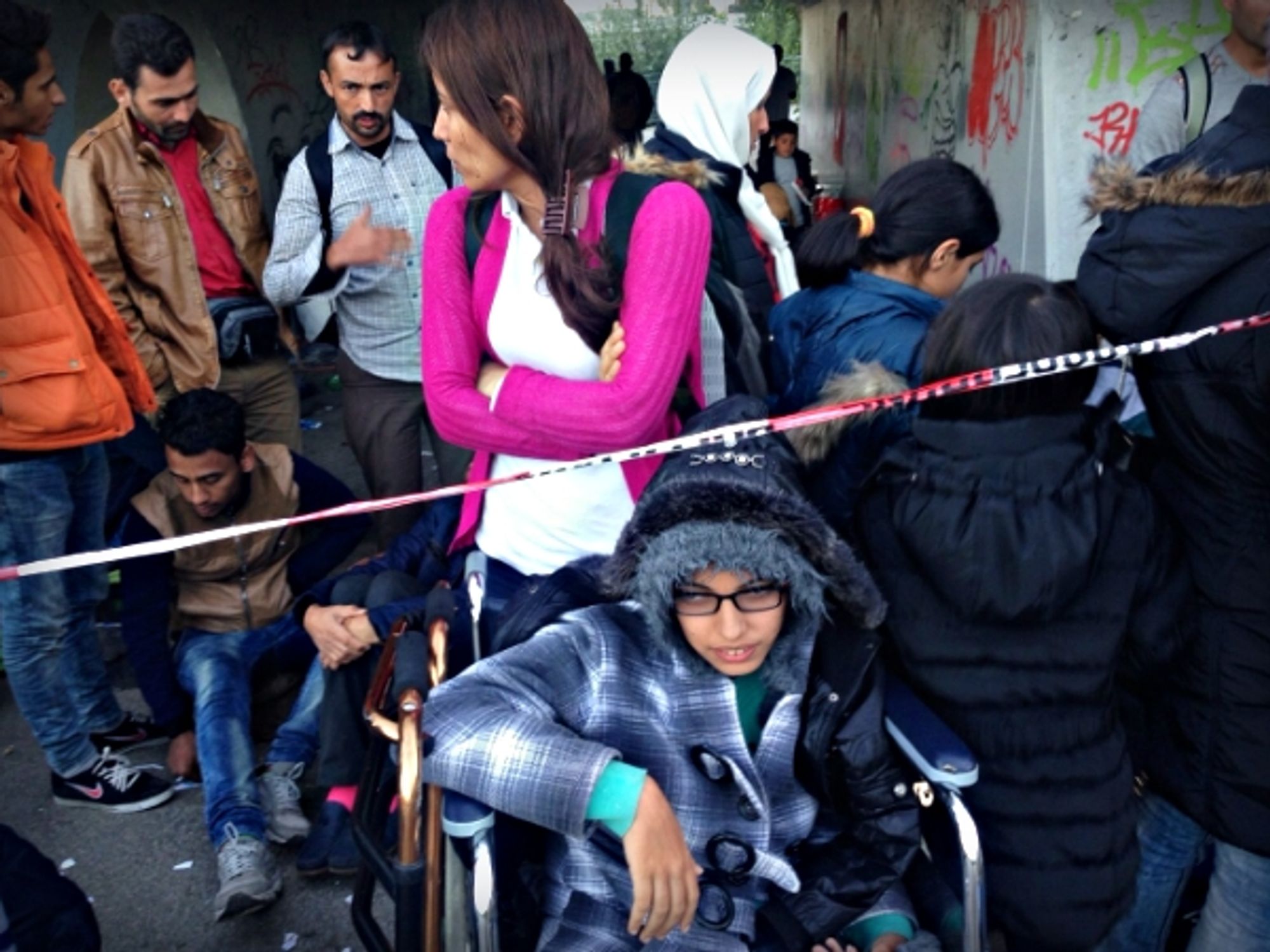 Nujeen and her sister waiting for a bus to take them to a camp in Germany