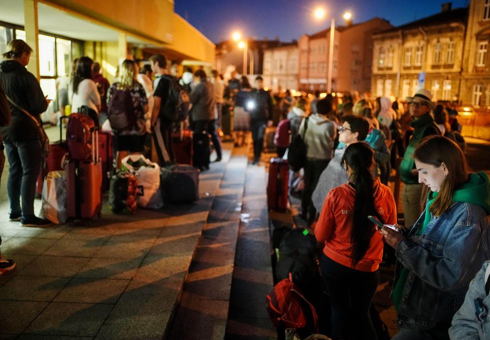 Numerous people are standing at the train station in the Polish border town of Przemysl, waiting for their onward journey to Ukraine.