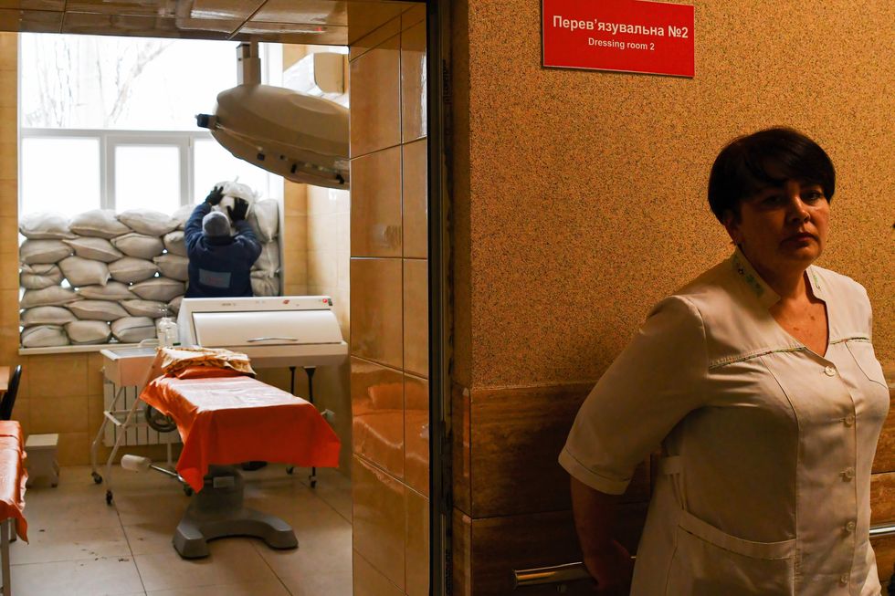 Nursing staff placing sand bags near the window for protection in Ukraine's Kramatorsk city hospital