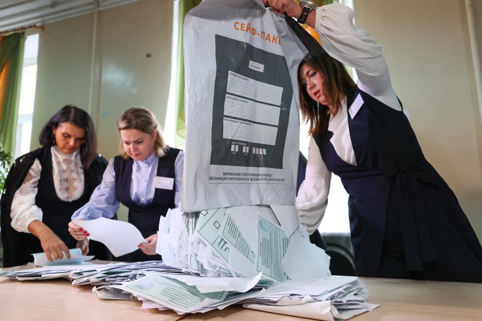 Officials count votes at a polling station in Donetsk during a referendum on the accession of the Donetsk People's Republic to Russia