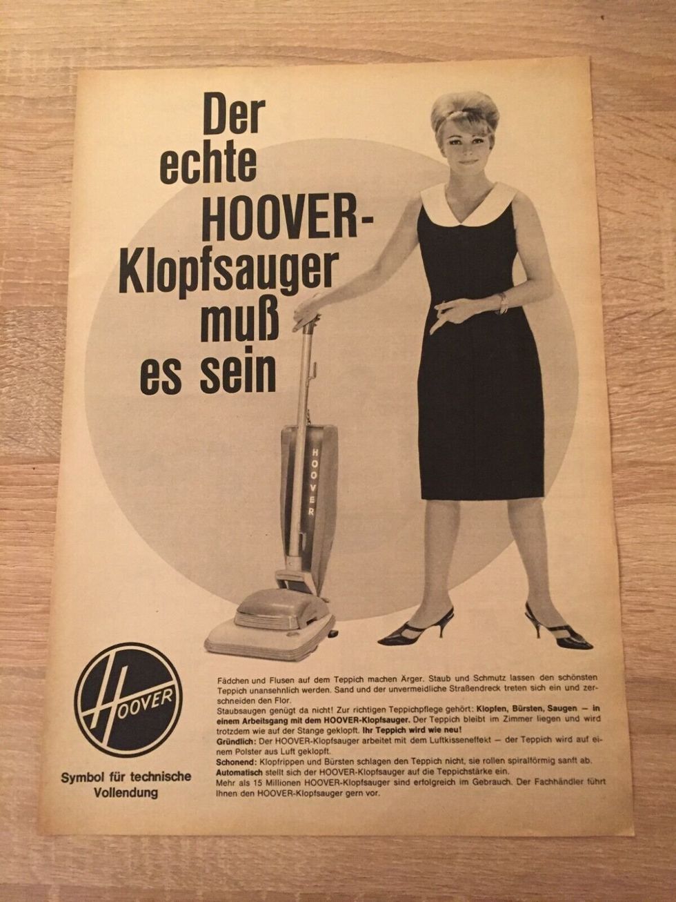On yellowing German leaftet for vacuum cleaner, a well dressed woman points at an upright Hoover