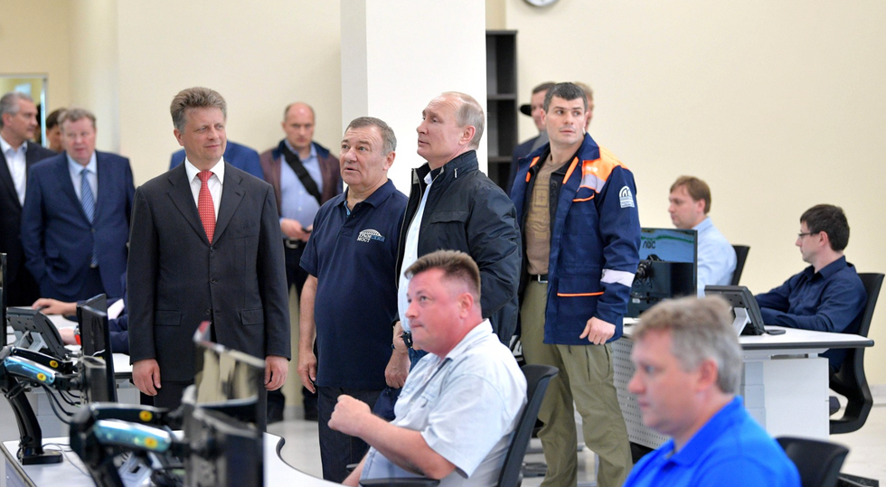 Opening of the Crimean Bridge on May 15, 2018, President Vladimir Putin stands alongside oligarch Arkady Rotenberg, in the blue polo shirt.