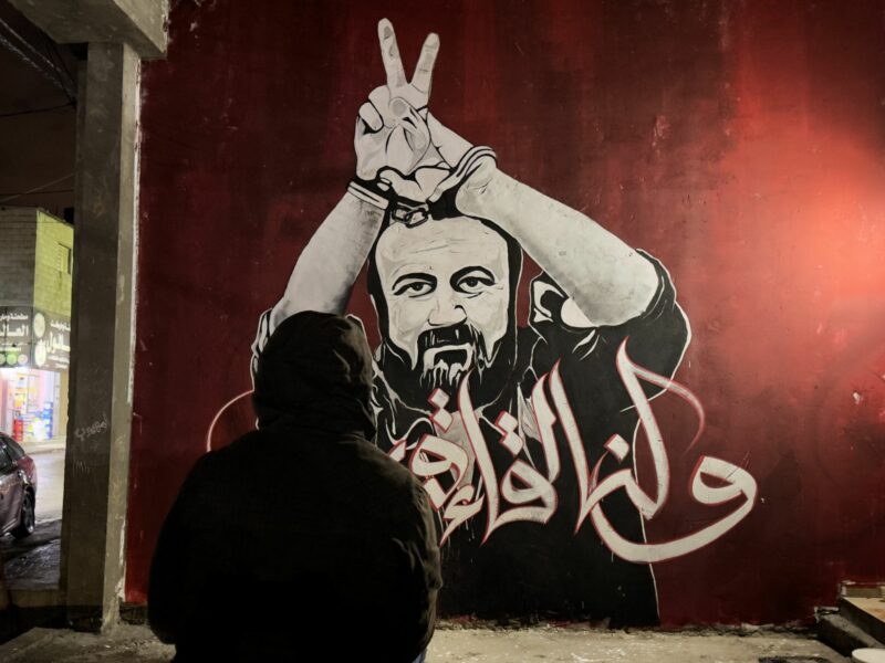 Palestinian artists work by a mural shows jailed Fatah leader Marwan Barghouti, in Jabalia refugee camp in the northern Gaza Strip.