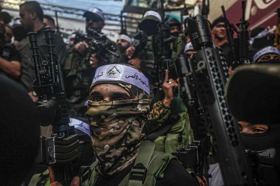 Palestinian gunmen from the Al-Aqsa Martyrs Brigades appear carrying their weapons during a military parade in the Balata refugee camp, east of Nablus, in the northern West Bank. A spokesman for Al-Aqsa Martyrs Brigades said during the parade that ''our battalions will continue the struggle until the liberation of Palestine.