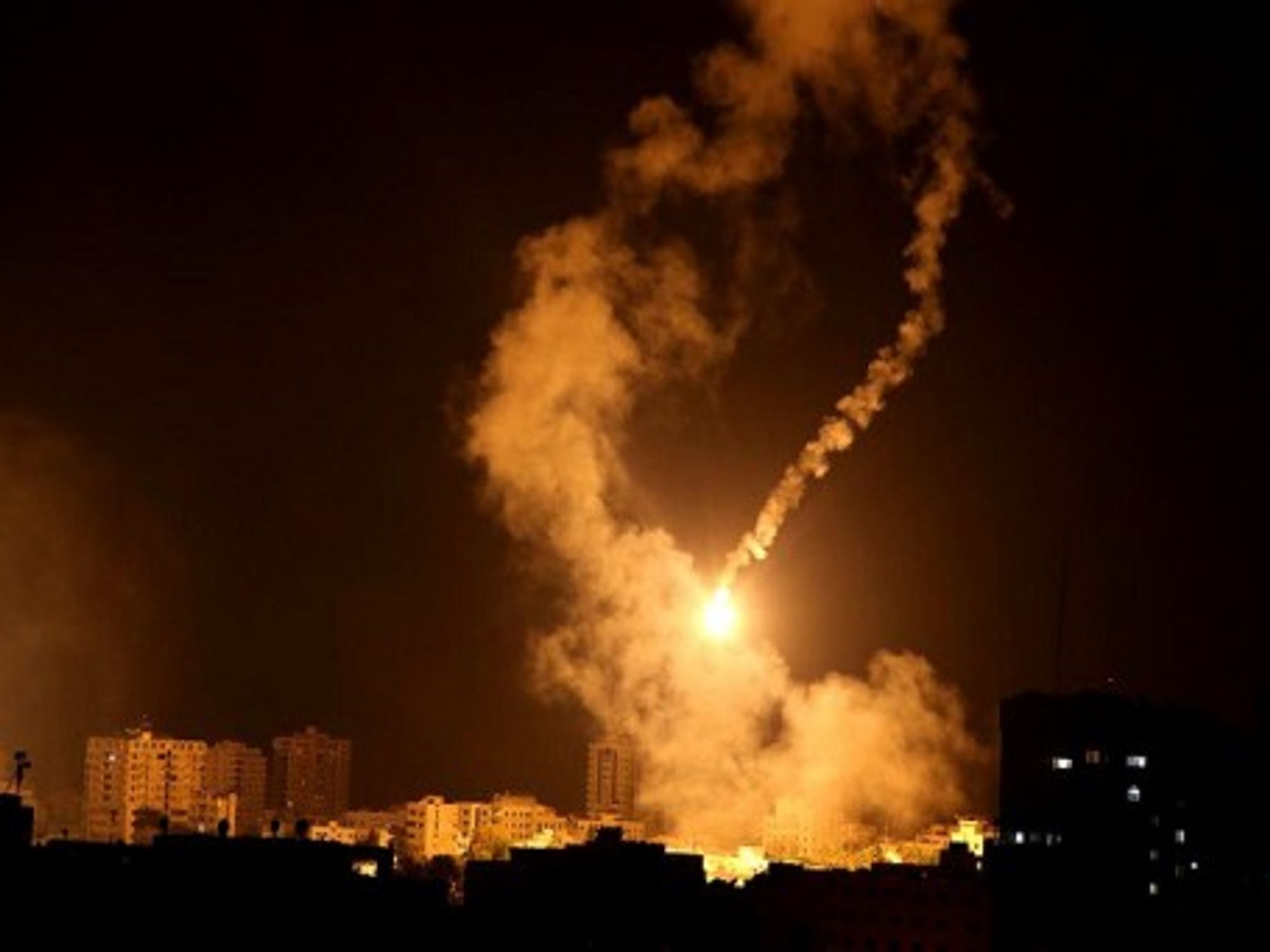 Palestinian houses lit up by Israeli light flares early Tuesday