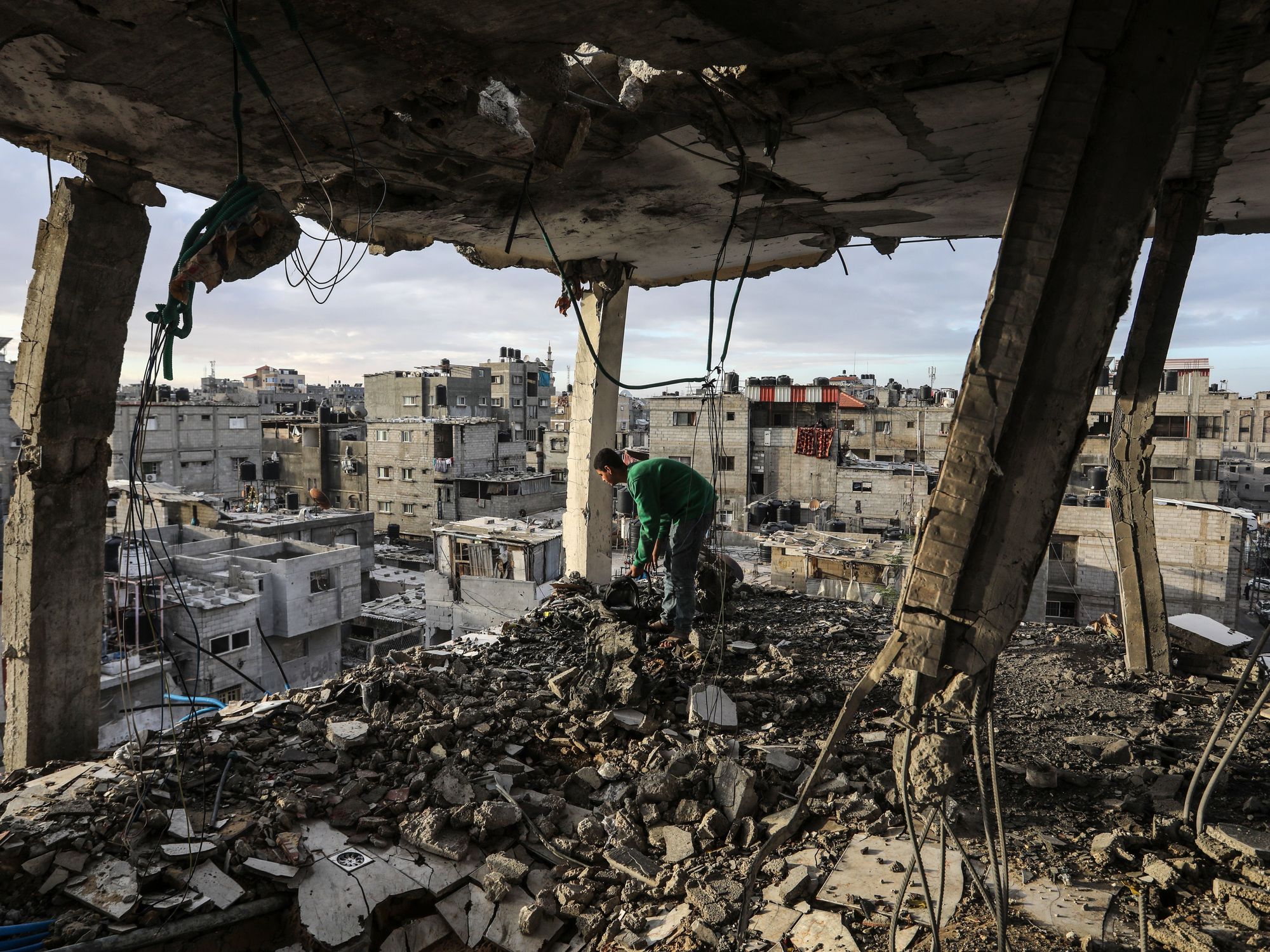 Palestinian inspects his home that was damaged after an Israeli air strike on the Shaboura refugee camp.