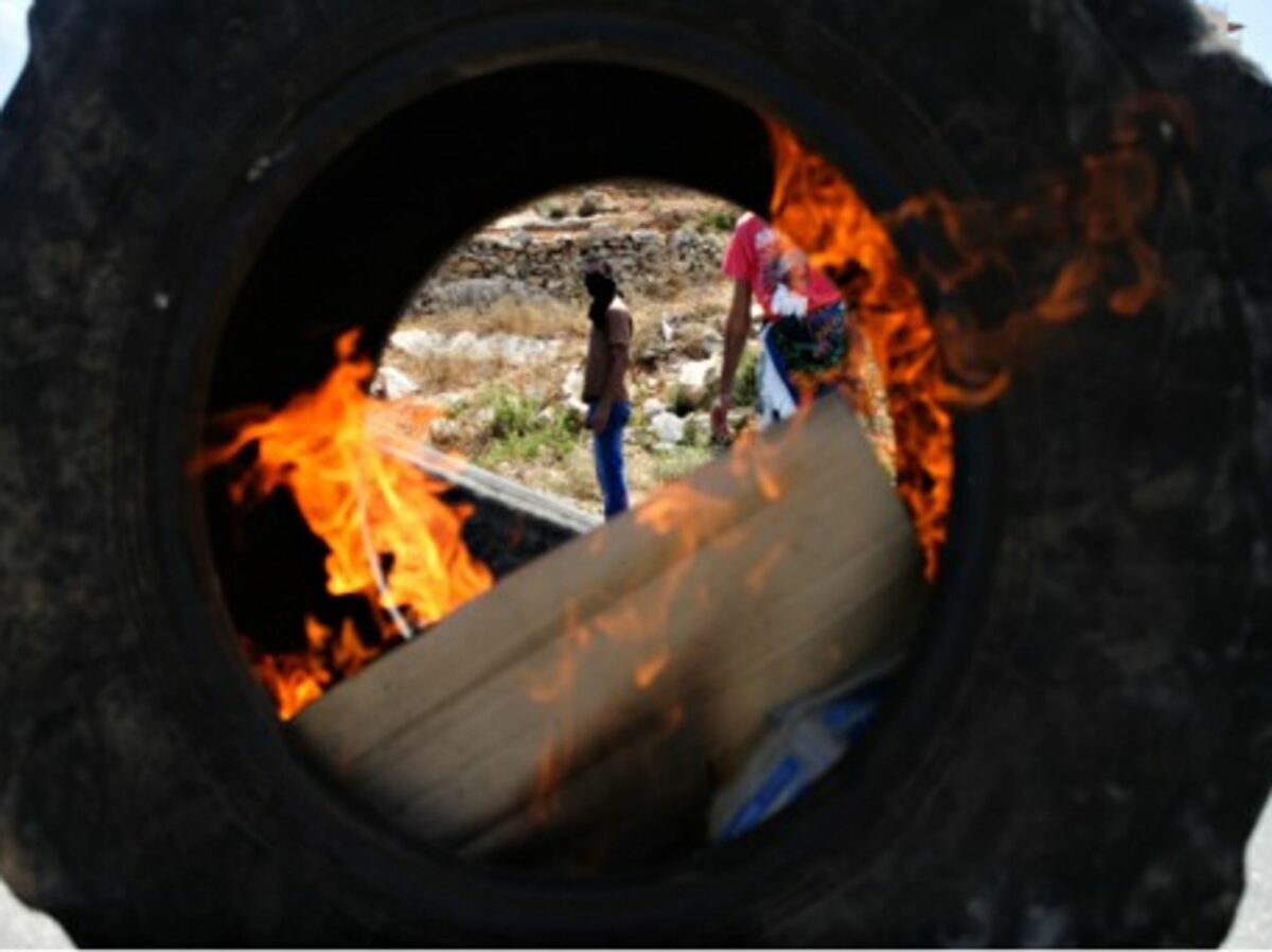 Palestinian protesters burning tires in Ramallah, West Bank, in solidarity with Gaza
