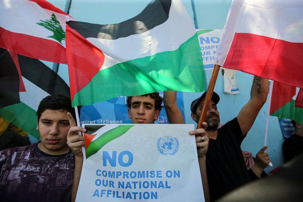 Palestinian refugees in Lebanon demonstrate outside the U.N. relief agency for Palestinian refugees (UNRWA) main office in Beirut in solidarity with the agency employees and Gaza.