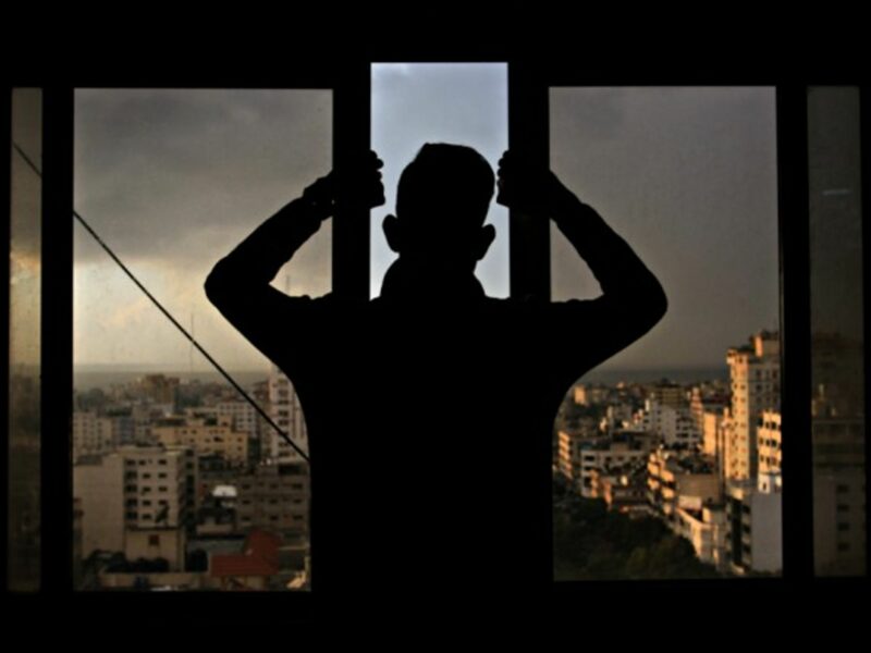 Palestinian youth looking over Gaza City