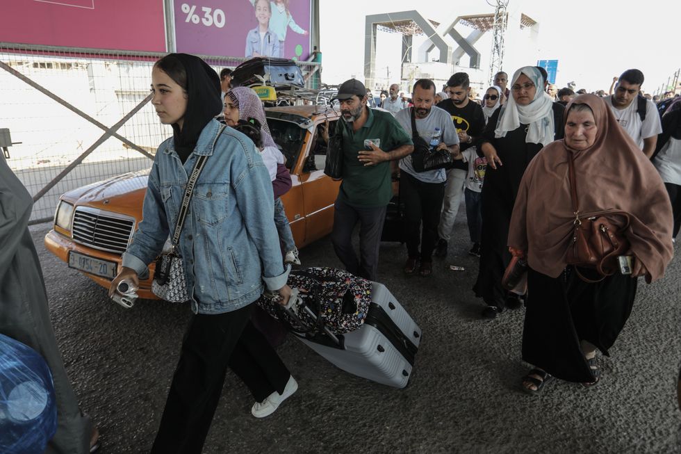 Palestinians are seen at the border crossing between Gaza and Egypt in Rafah.