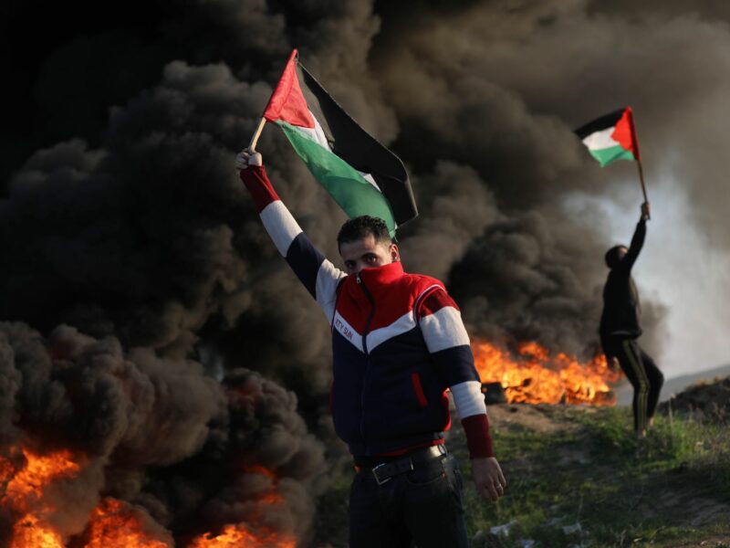 Palestinians burn tires during a protest against the killing of 9 Palestinians during an Israeli raid in Jenin near the fence with Israel east of Gaza city on January 26, 2023.