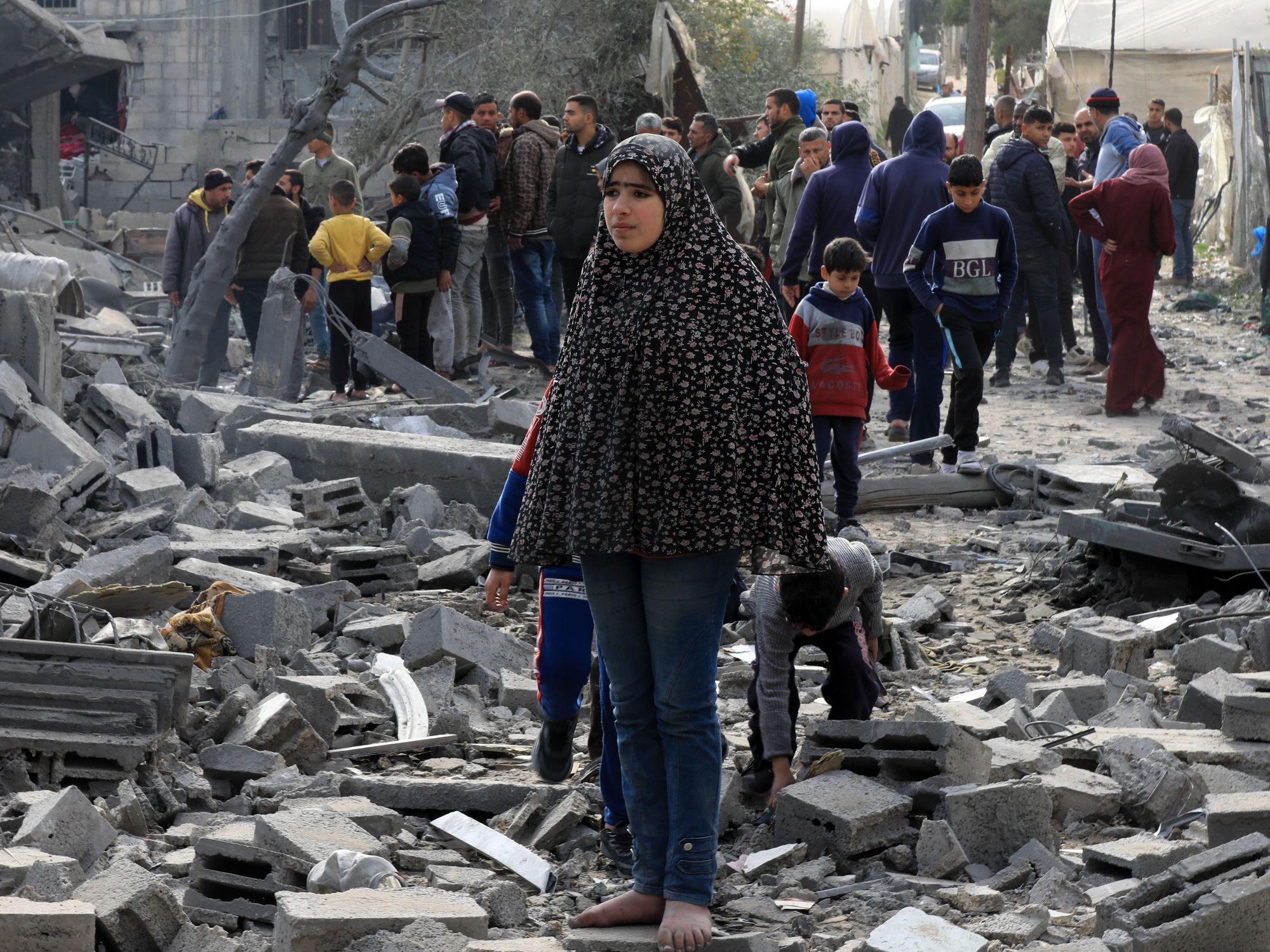 Palestinians check the rubble of buildings damaged by Israeli airstrikes in the southern Gaza Strip city of Rafah.​