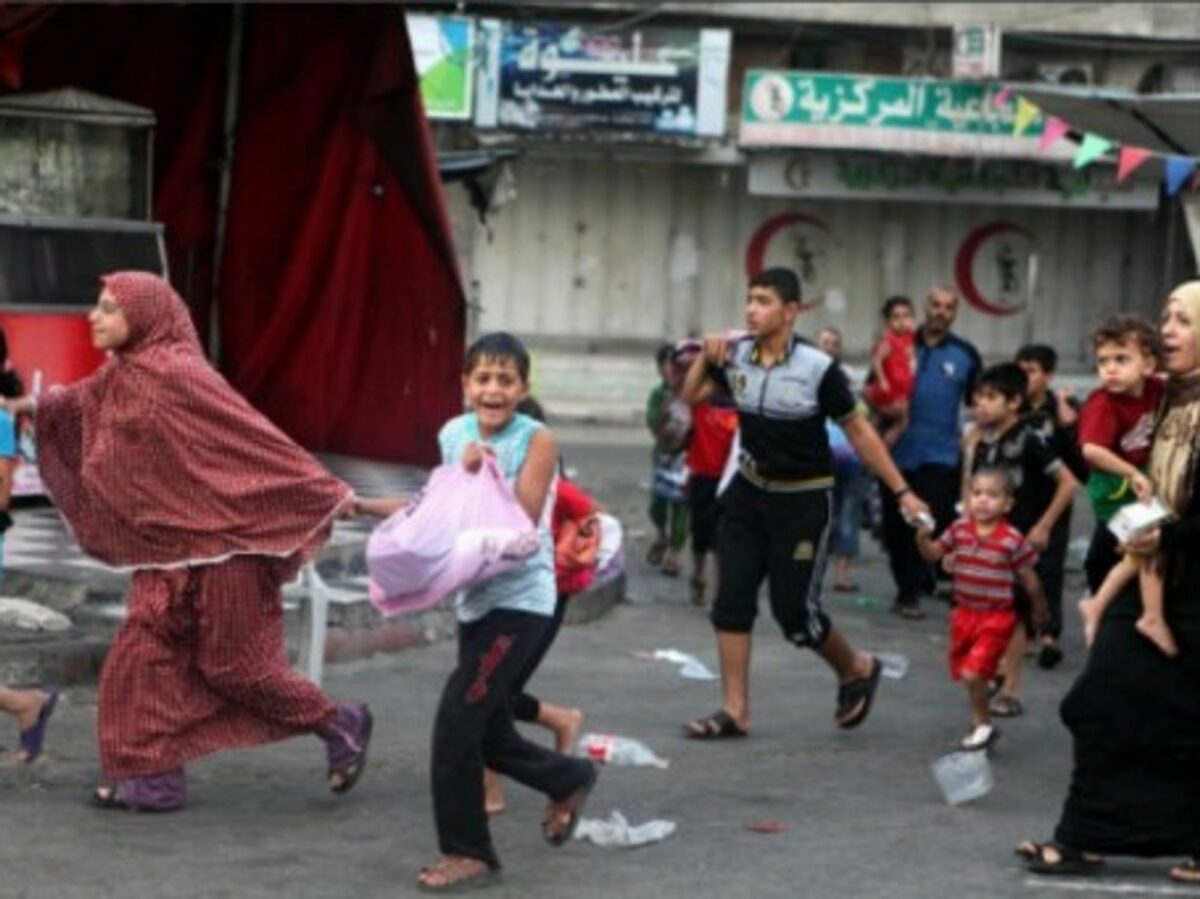 Palestinians flee the Shujayeh neighborhood during heavy Israeli shelling in Gaza City.