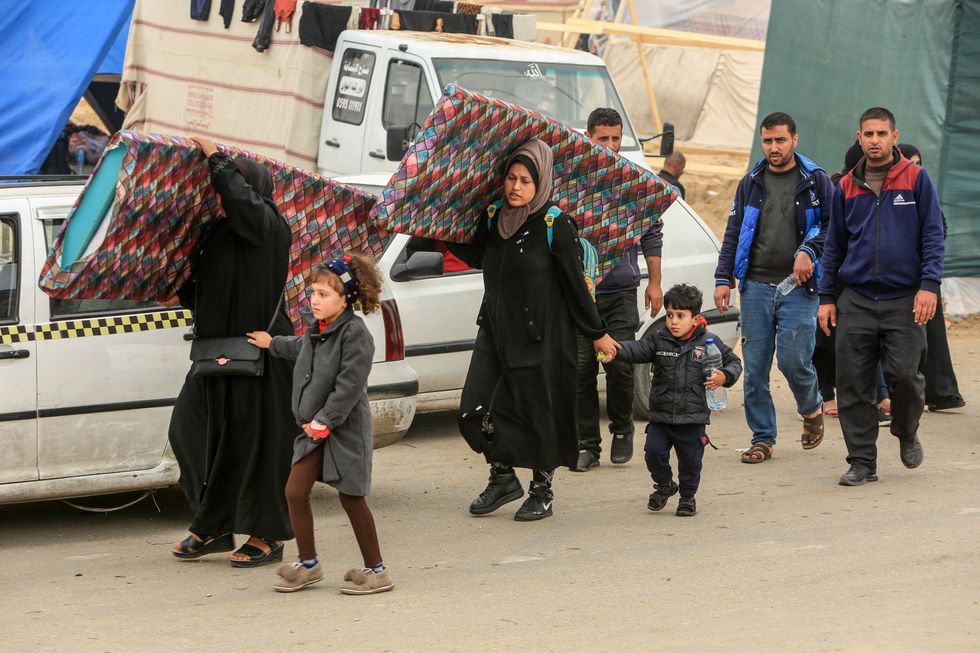 Palestinians fleeing fierce battles between the Israeli army and Hamas from the city of Khan Younis towards the city of Rafah in the southern Gaza Strip