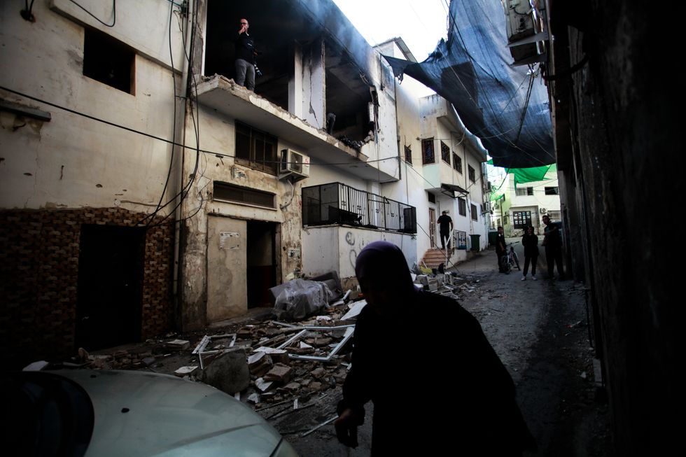 Palestinians inspect damaged buildings after an Israeli military raid in Jenin refugee camp in the West Bank.