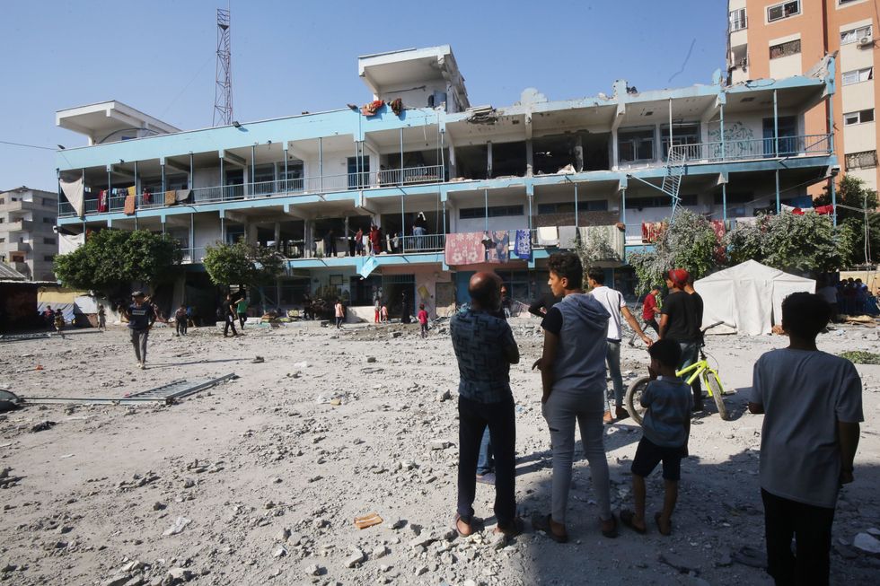 Palestinians inspect the damaged school following an Israeli airstrike on a school for displaced persons belonging to the United Nations Relief and Works Agency for Palestine Refugees.​