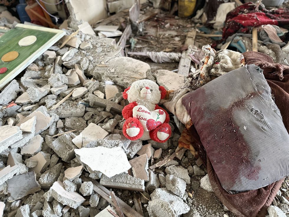 Palestinians inspect the rubble of destroyed buildings following Israeli airstrikes in Al Nuseirat refugee camp, central Gaza Strip, 10 December 2024.