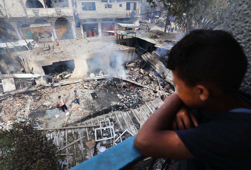 Palestinians inspect the site of an Israeli strike on a school sheltering displaced people, amid the ongoing Israel war on Gaza, in Nuseirat refugee camp in the central Gaza Strip.