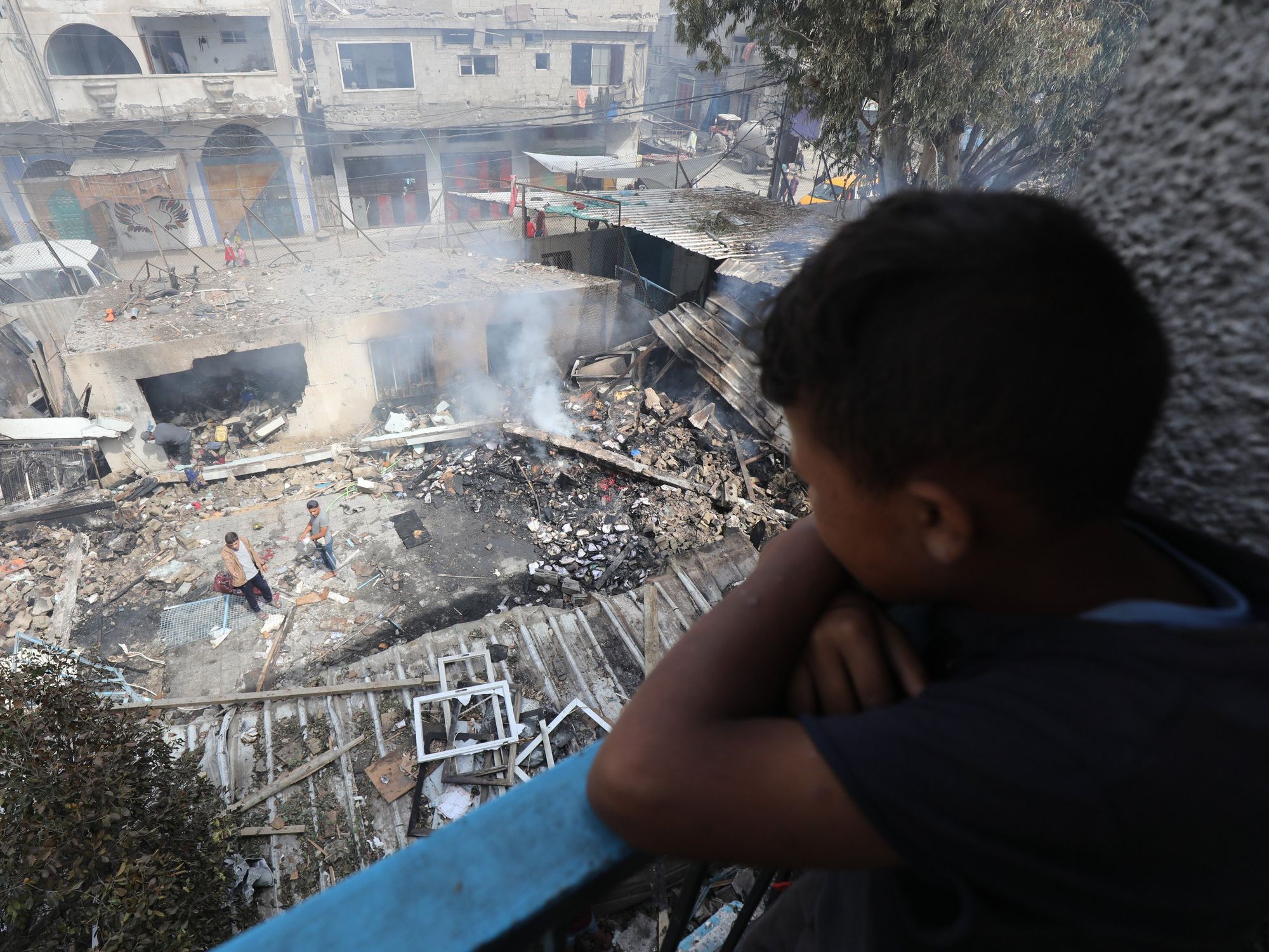 Palestinians inspect the site of an Israeli strike on a school sheltering displaced people, amid the ongoing Israel war on Gaza.