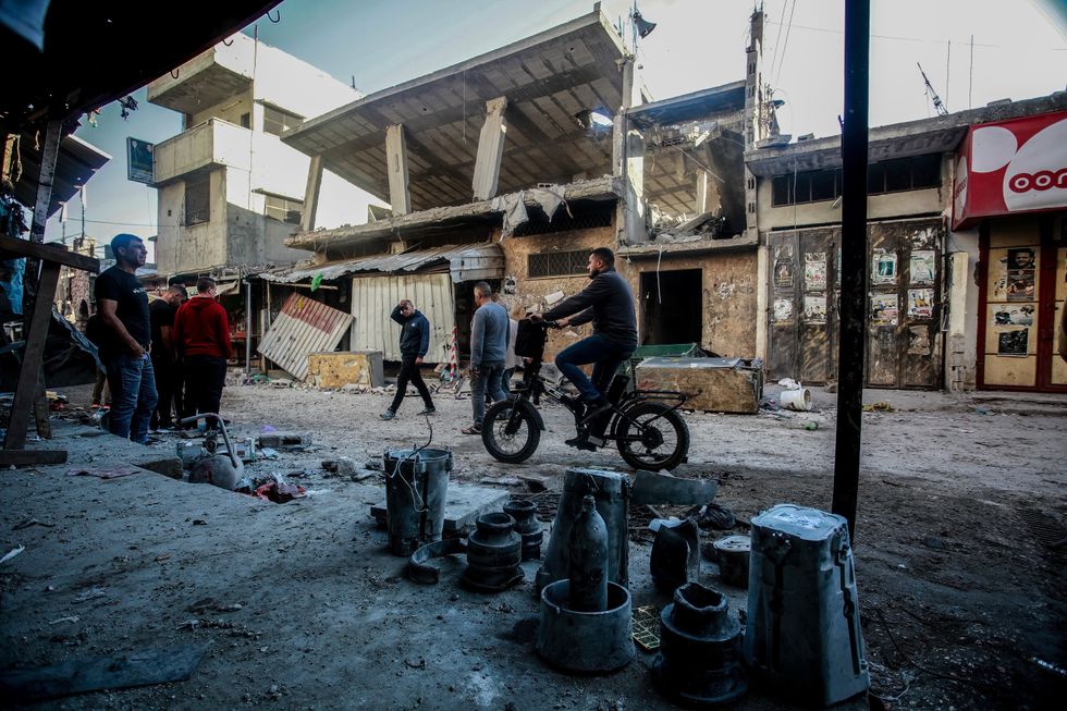 Palestinians inspect the site where the Israeli military struck what it said was a hideout for militants, in the Balata refugee camp, West Bank.