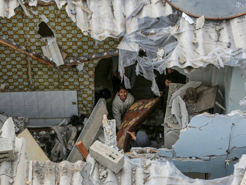 Palestinians inspect their homes that were damaged after an Israeli air strike.