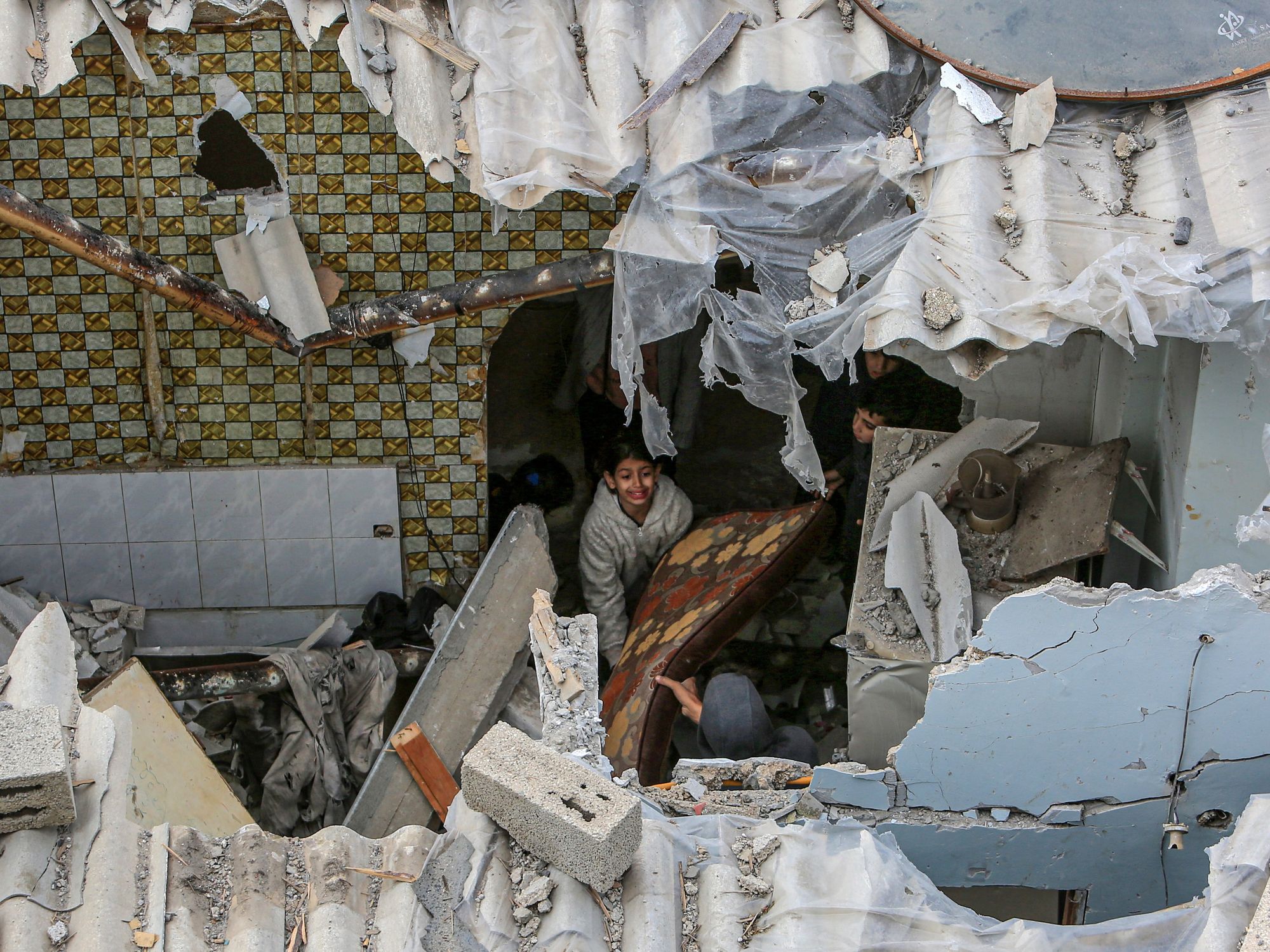 Palestinians inspect their homes that were damaged after an Israeli air strike.
