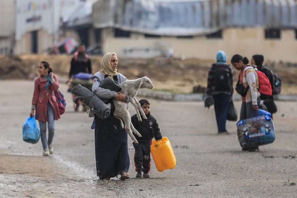 Palestinians leave the area of Nasser Hospital and the adjacent schools in Khan Younis in the southern Gaza Strip after the Israeli army ordered people to evacuate certain parts of the city immediately.