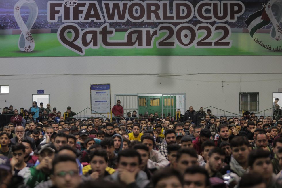 Palestinians watch the broadcast of the 2022 World Cup match between Saudi Arabia and Poland in Gaza City