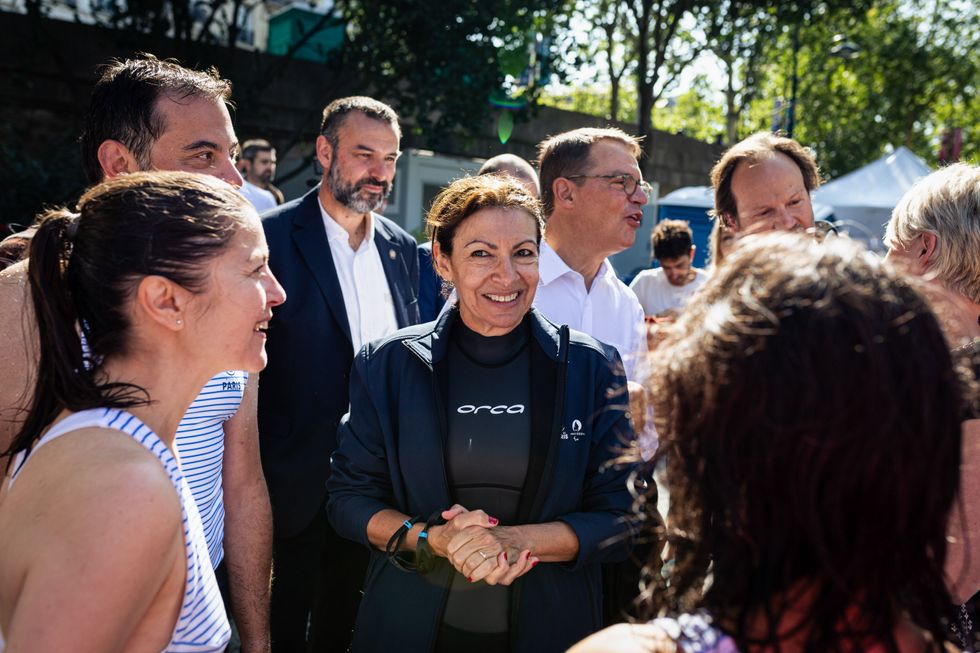 Paris Mayor Anne Hidalgo talks to swimmers from the Ourcq Polaires collective after swimming in the Seine River.